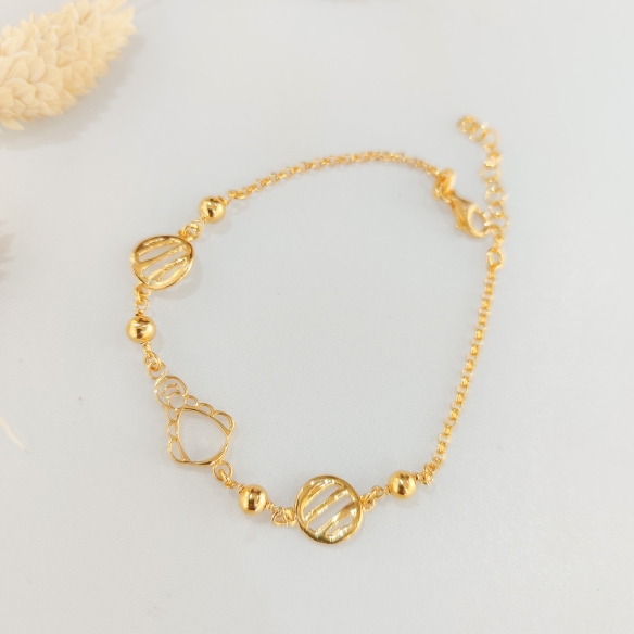 Pulsera silueta y círculo con rayas baño oro